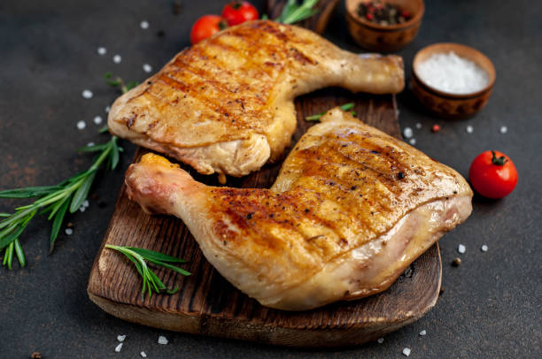 istock two grilled chicken legs with spices on a cutting board on a stone background 1316042277