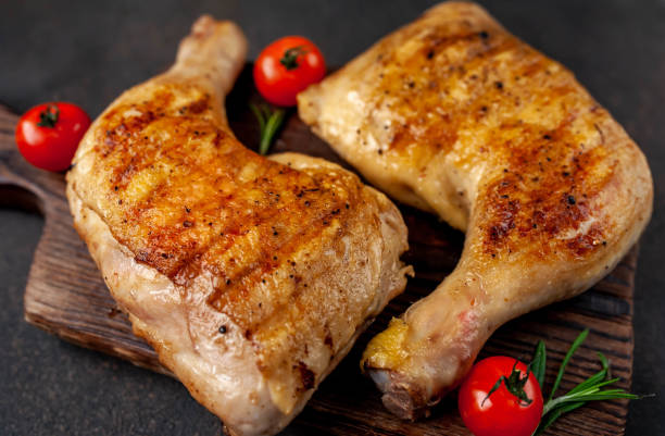 istock two grilled chicken legs with spices on a cutting board on a stone background 1316042438