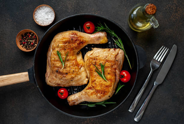 istock two grilled chicken legs with spices on a grill pan on a stone background 1316042694