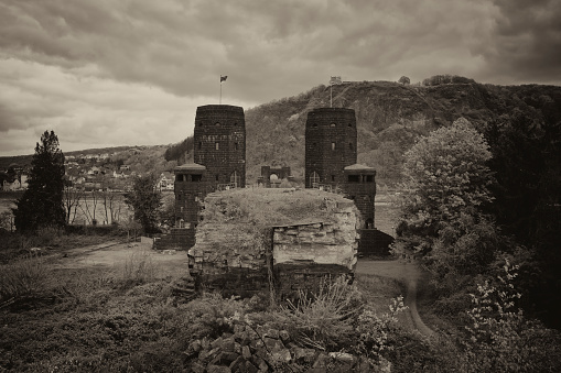 Ruin of the railroad bridge that crossed the Rhine near Remagen until the end of the Second World War. Sepia toned black and white image.