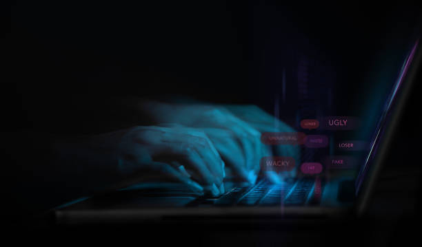 istock Cyber Bullying and Racist via Internet Concept. World Social Issue. Motion Blurred image of Person Using Computer Laptop to making Others feeling Sad by Bad Message. Parody and Intimidation 1316054229