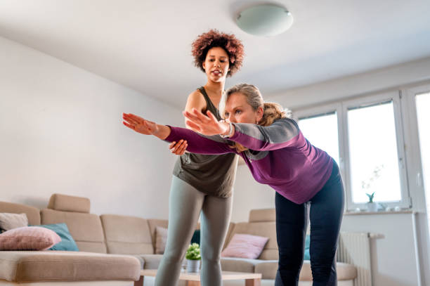 istock Two women exercising in a living room 1316056007