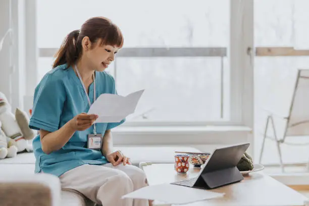 Photo of Woman paying bills at home