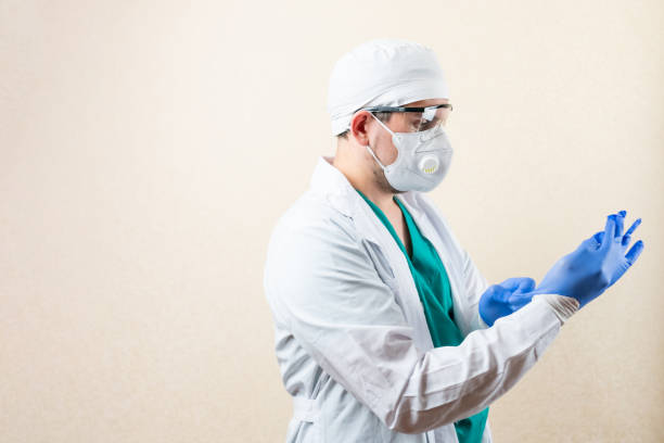 istock The doctor puts on gloves. On a light background. 1316056871