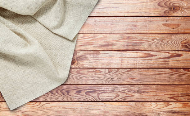 istock Napkin. Stack of dish towels on wooden desk. Top view 1316057521