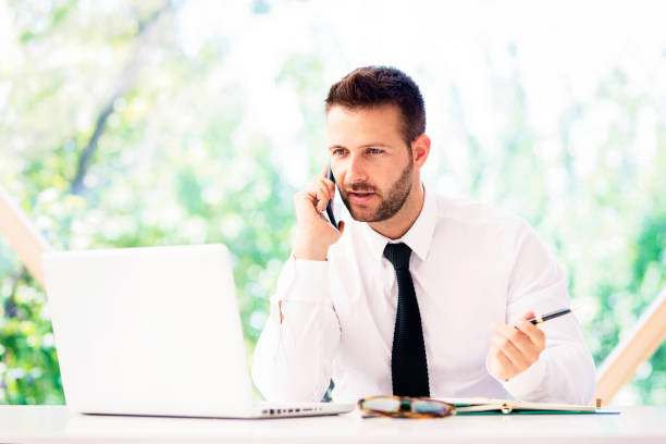 istock Businessman having a business call and using laptop while working in the office 1316061138