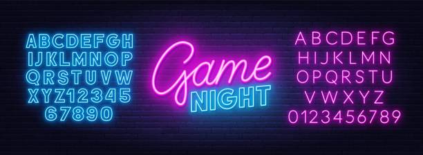 illustrazioni stock, clip art, cartoni animati e icone di tendenza di segno al neon della notte di gioco su sfondo muro di mattoni. alfabeto blu neon e rosa. - fluorescente