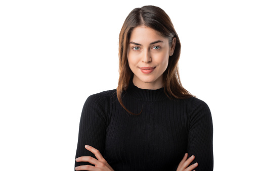 Studio portrait of beautiful brown haired woman standing at isolated background.