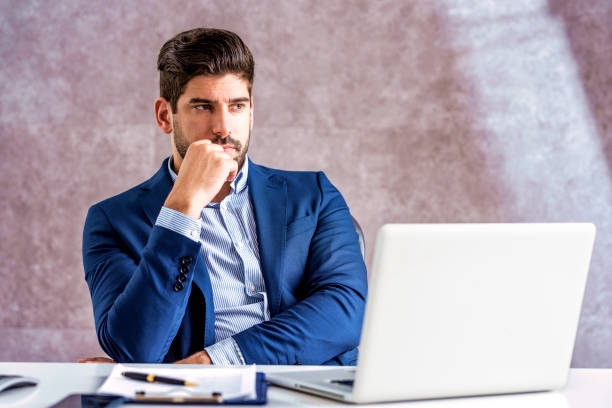 istock Shot of thinking businessman using laptop while sitting in the office and working 1316064050