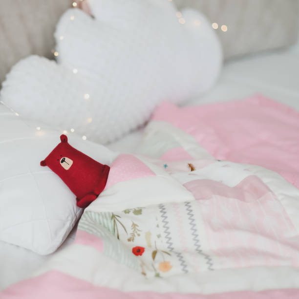 istock Cozy baby cot with pink patchwork blanket. Baby bedding. Bedding and textile for nursery. Nap and sleep time 1316064173