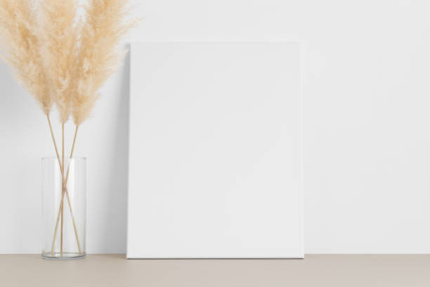 istock White canvas mockup with a pampas on the beige table. 1316065947