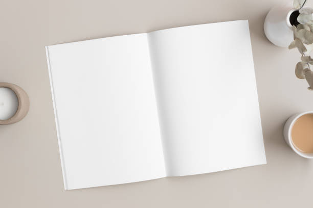 istock Open magazine mockup with a book, candle and a  eucalyptus on the beige table. 1316066017