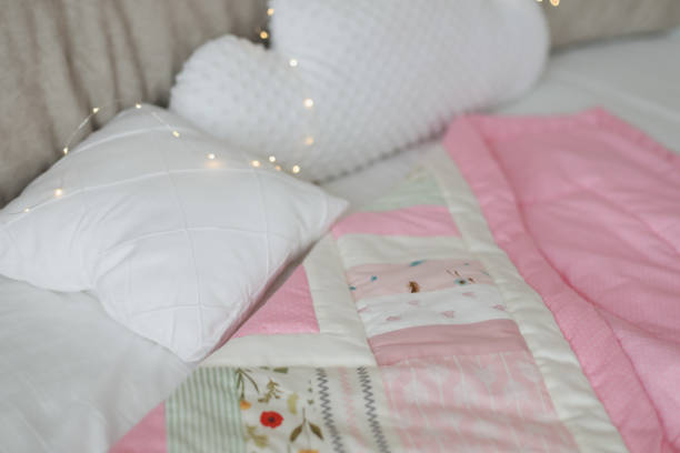 istock Cozy baby cot with pink patchwork blanket. Baby bedding. Bedding and textile for nursery. Nap and sleep time 1316066170