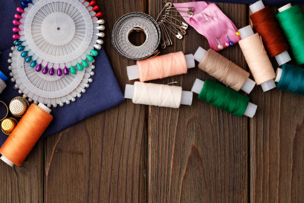 istock Threads and sewing accessories on brown wooden table 1316066223