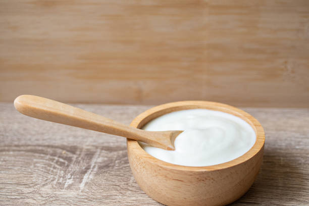 istock White yogurt in a wooden cup with a wooden spoon 1316069152