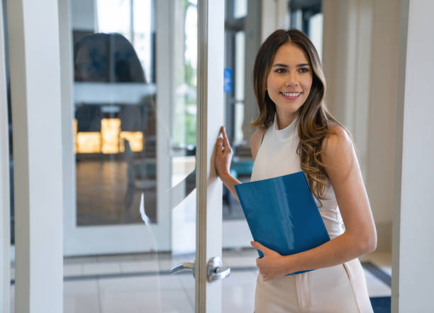 Happy Real Estate Agent showing a house