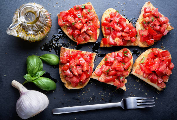istock Tomato bruschetta on slate stone background. Top view. 1316070364