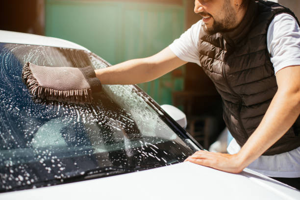 istock Handsome man washing car 1316070541