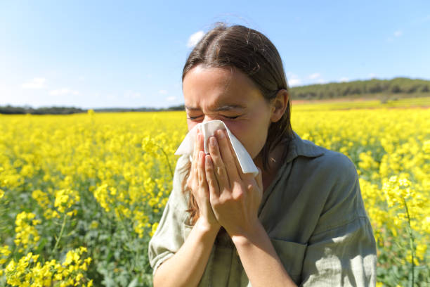 istock Woman suffering allergy coughing in a field in spring 1316072316
