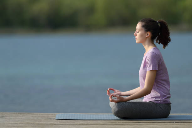 istock Yogi practicing yoga in a pier beside a lake 1316072365