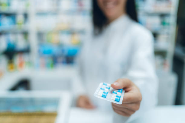 istock Female pharmacist offering medicine in blister pack 1316075030