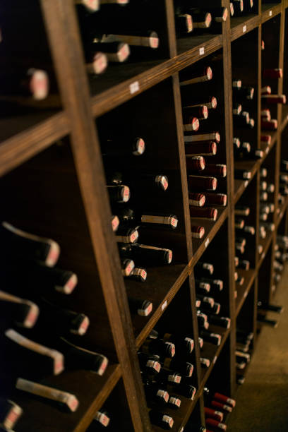 istock Red wine bottles stored in a wine cellar of a winery 1316076848