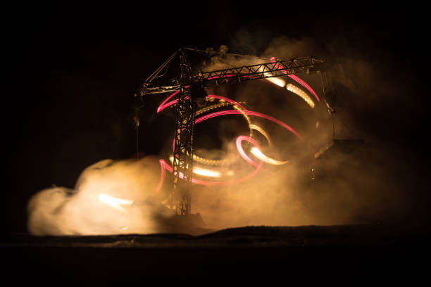 istock Abstract Industrial background with construction crane silhouette over amazing night sky with fog and backlight. Tower crane against the foggy sky at night. 1316077145