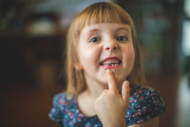 Happy Little Girl Showing Her Tooth Gap Portrait of a cute little girl with a wonderful toothless smile gap toothed stock pictures, royalty-free photos & images