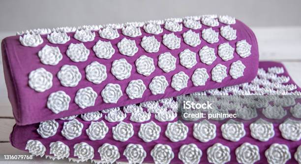 Purple Massage Acupuncture Mat With Pillow And White Massage Tips Stock Photo - Download Image Now