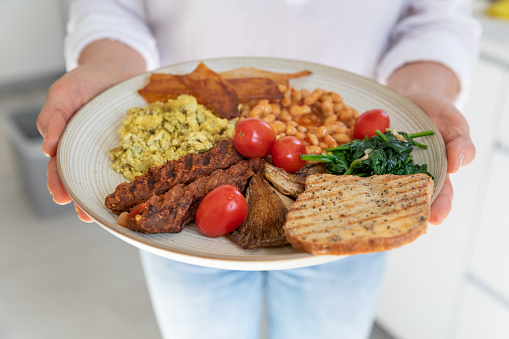 Toast, vegan sausage, tofu eggs, spinach, baked beans, coconut chips, mushrooms and grape tomatoes