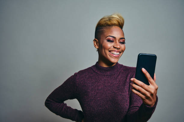 istock Female Hipster Taking Selfie Against Gray Background 1316088088