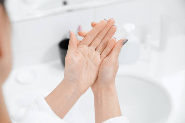 istock Woman washing hands with soap in modern bathroom. 1316089302