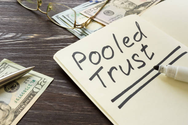 istock Pooled trust sign on the page and cash. 1316089327