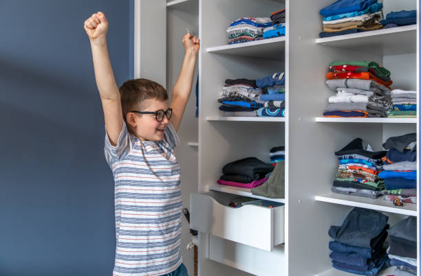 istock Cheerful little boy near a wardrobe with clothes. 1316089868