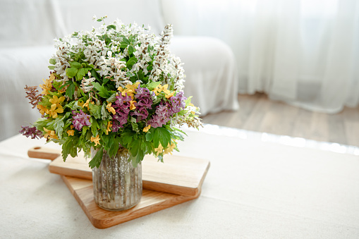 A table decorated with vases and flower bouquets