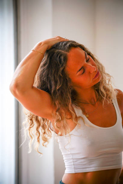 istock Young woman practices yoga in indoor studio 1316091376