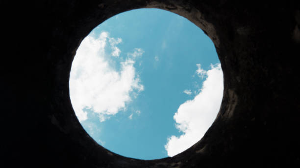 istock view of the blue sky through a round hole 1316092098