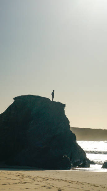 istock Young man stands on coastal cliff in the morning 1316092842