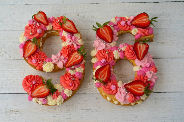 istock Birthday cake. Unusual modern design with strawberries. Spring time. Postcard for the holiday. Beautiful cake in the shape of number 96 on rustic white wooden background 1316093138