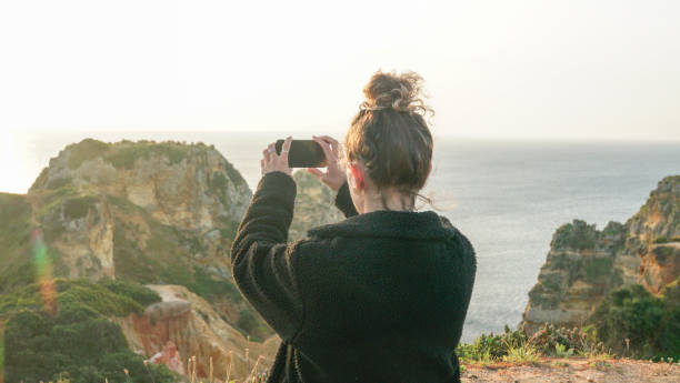 istock Young woman relaxes on coastal cliffs at sunrise 1316094227