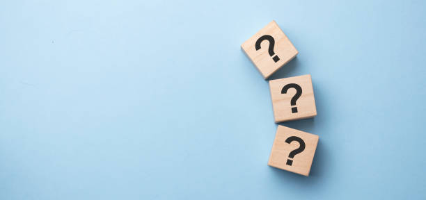 istock Wooden cube block shape with sign question mark symbol on wood table. 1316094380