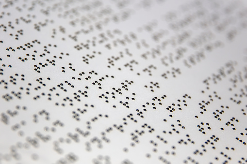 Braille alphabet signs on the white paper