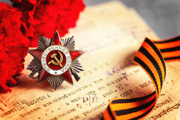 istock The Soviet order of the Second World war and red carnations. postcard 1316097617