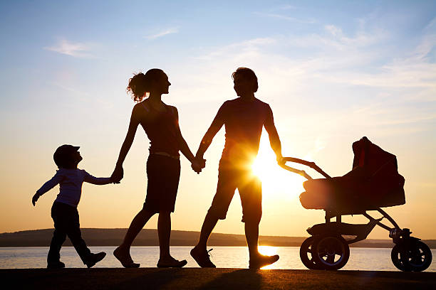 Family walk at sunset stock photo