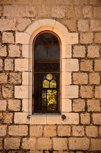 Interesting old window  in an old brick church in Jerusalem in Israel