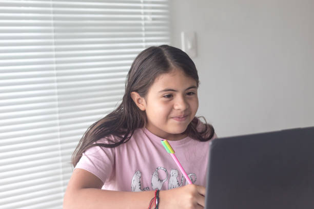istock Small girl working on her school project at home. New normal 1316100049