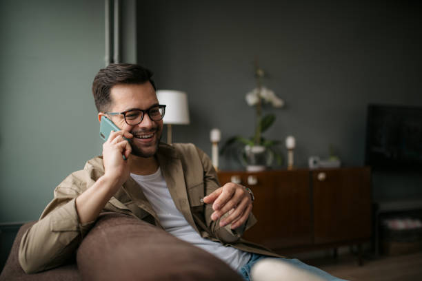 istock Handsome young Caucasian man using a smart phone at home 1316101132