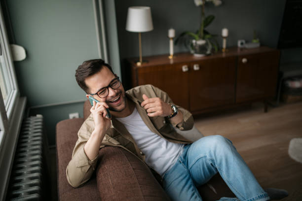 istock High angle view of a handsome young Caucasian man using a smart phone at home 1316101171