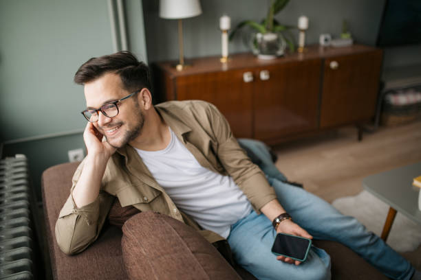 istock High angle view of a handsome young Caucasian man using a smart phone at home 1316101284