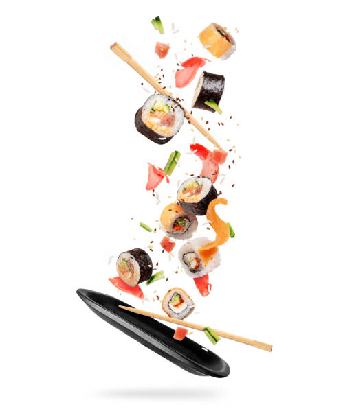 istock Fresh sushi rolls with various ingredients falling on a black clay plate 1316102293